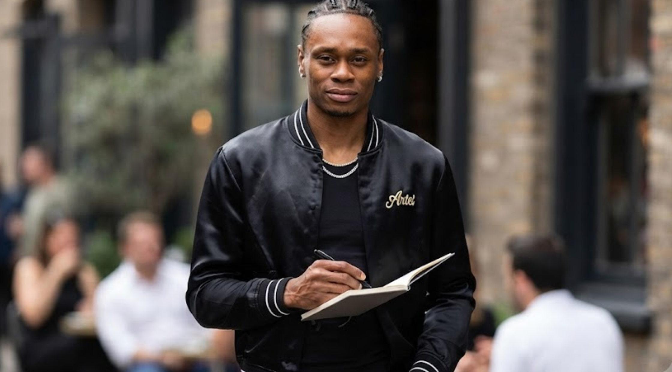 Peyton Watson Paris Fashion Week 2026 Black Satin Club Amiri Hollywood Varsity Bomber Jacket